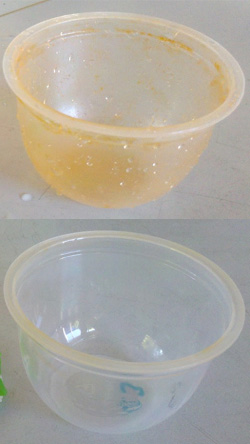 Ein Kunststoffbecher nach 2 Wochen mit Karotin gefüllt: der unbeschichtete Becher und unten der beschichtete Becher mit Barriere Wirkung